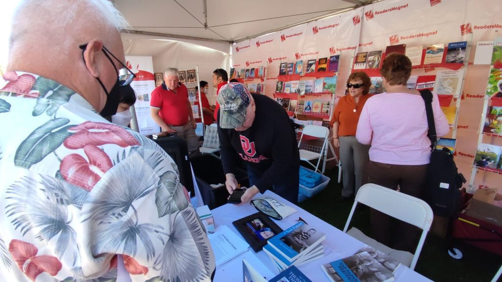 A book fair booth with the name "Readers Magnet" displayed.