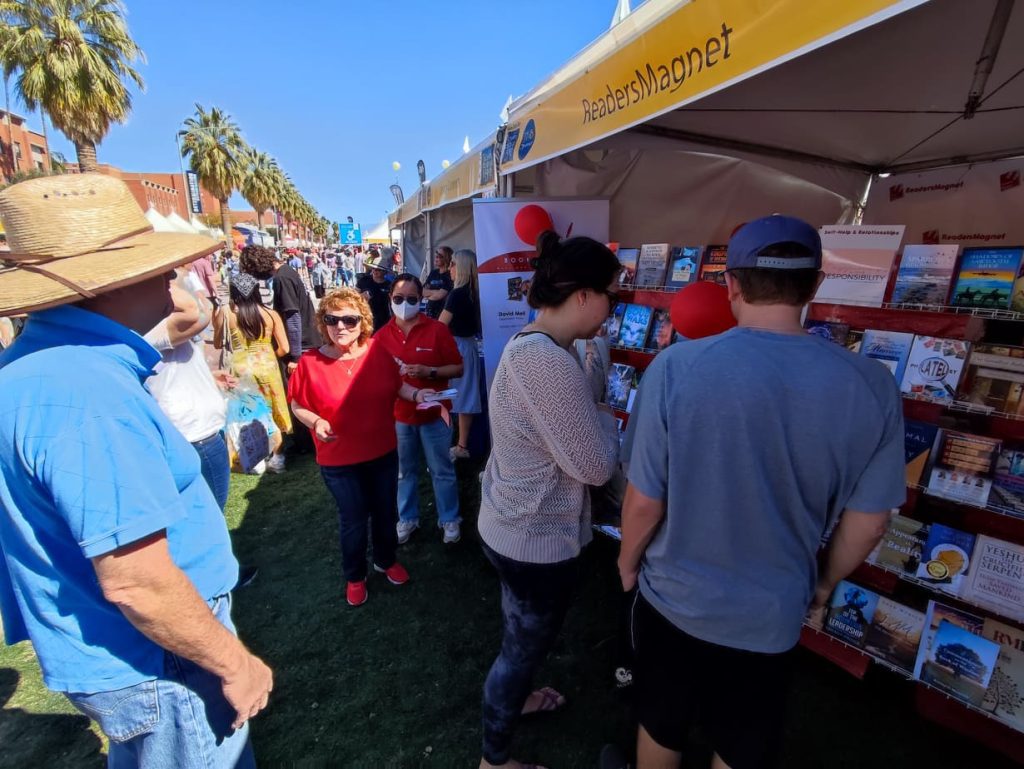 A book fair booth with the name "Readers Magnet" displayed.
