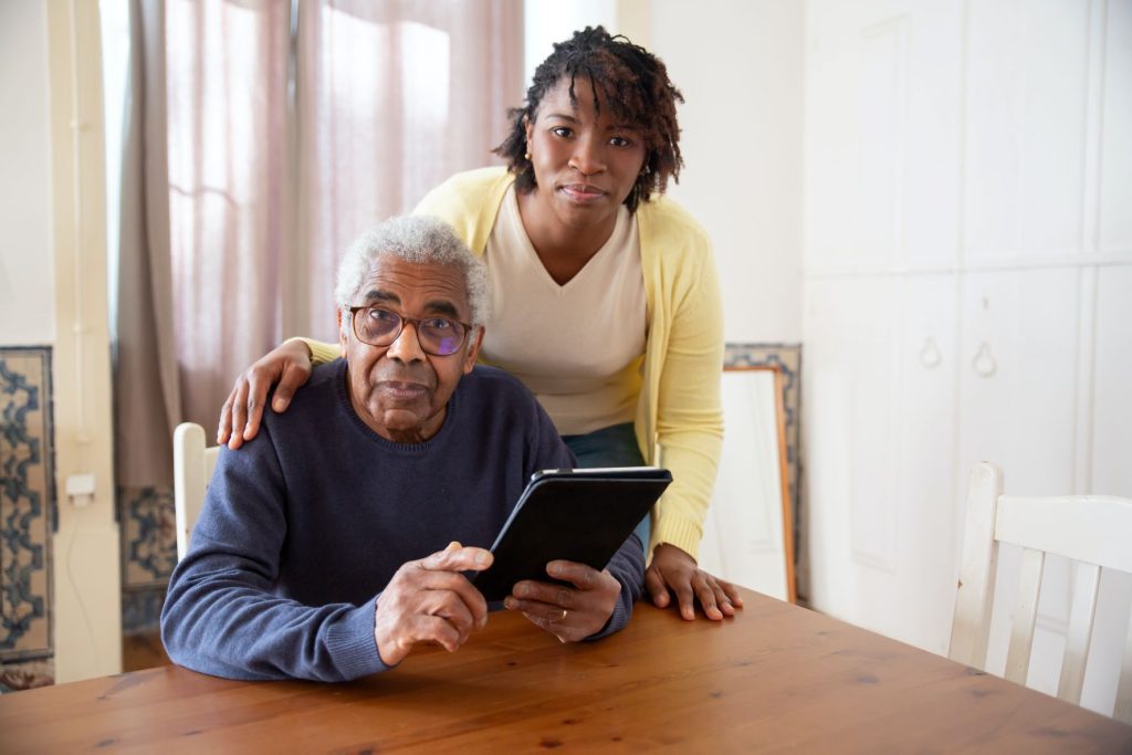 a young woaman taking care of an older man