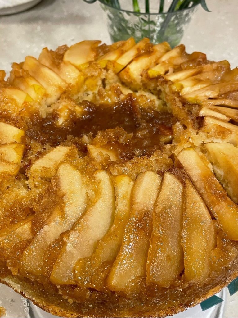 A golden brown pear cake with a caramelized topping