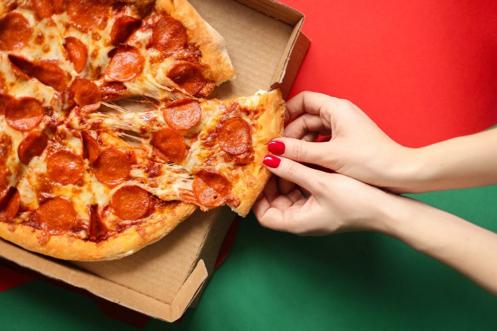 person holding a pizza
