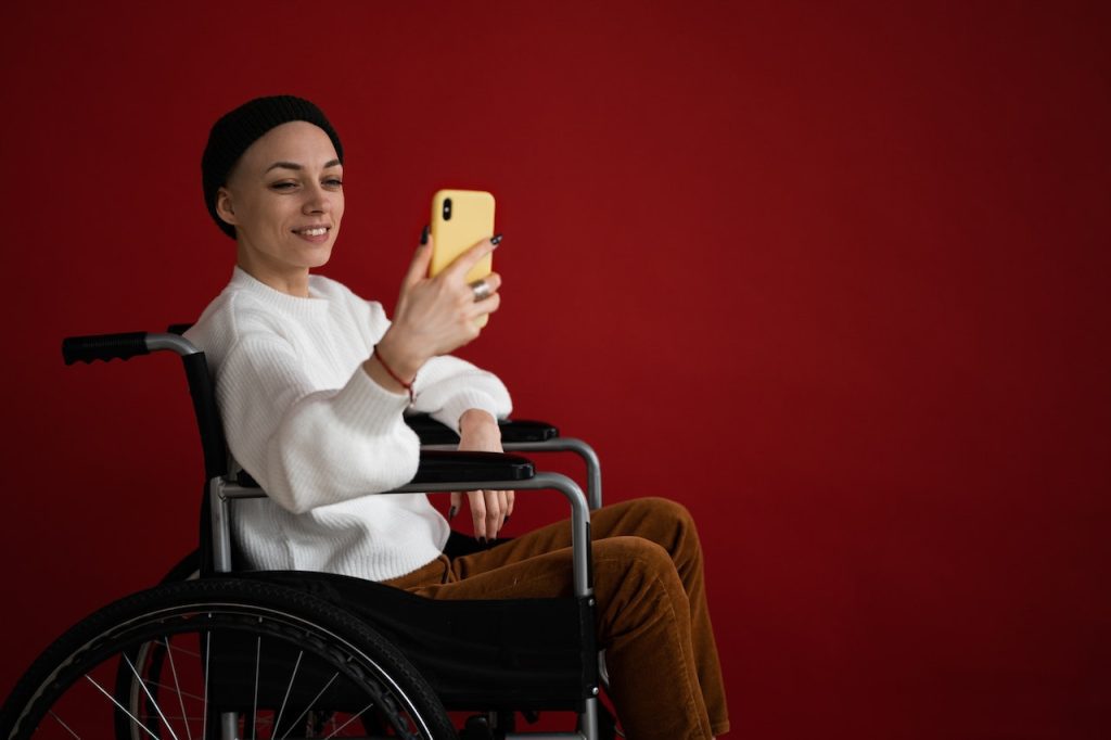 woman in wheelchair taking selfie maintaining a sense of independence