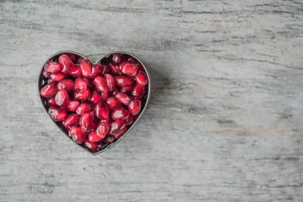 A heart-shaped bowl full of fruits.