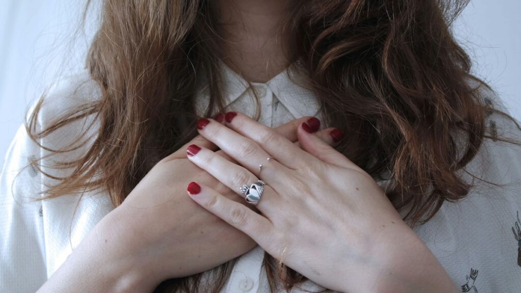 A person placing her hands on her chest, showcasing the caregiver’s guide to self-advocacy.