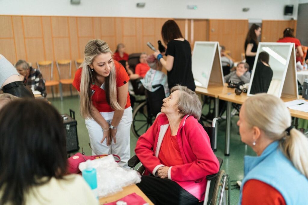 A caregiver talking to an elderly, depicting the power of support groups in caregiving.