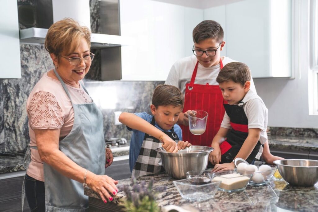 Photo of a woman cooking with her grandchildren, conveying why old recipes taste better.