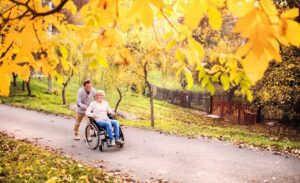 Man Pushing His Mother On A Wheelchair