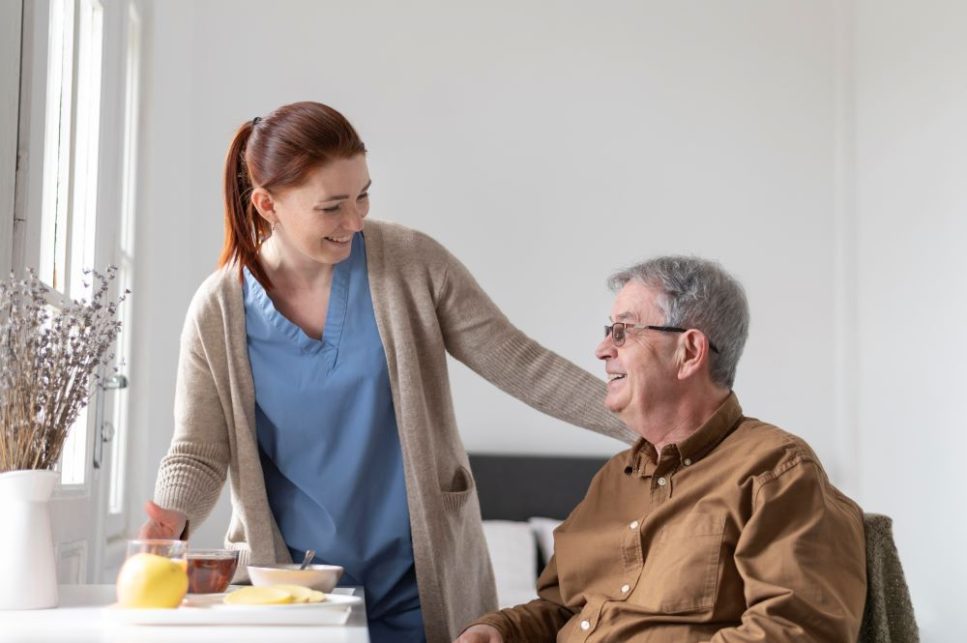 man smiling with female caregiver