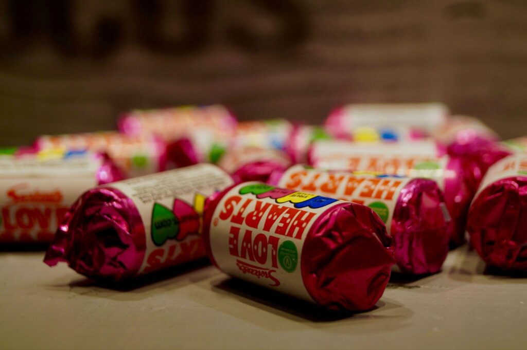 A colorful pile of pink and red wrapped candies, perfect for fun DIY candy treats.
