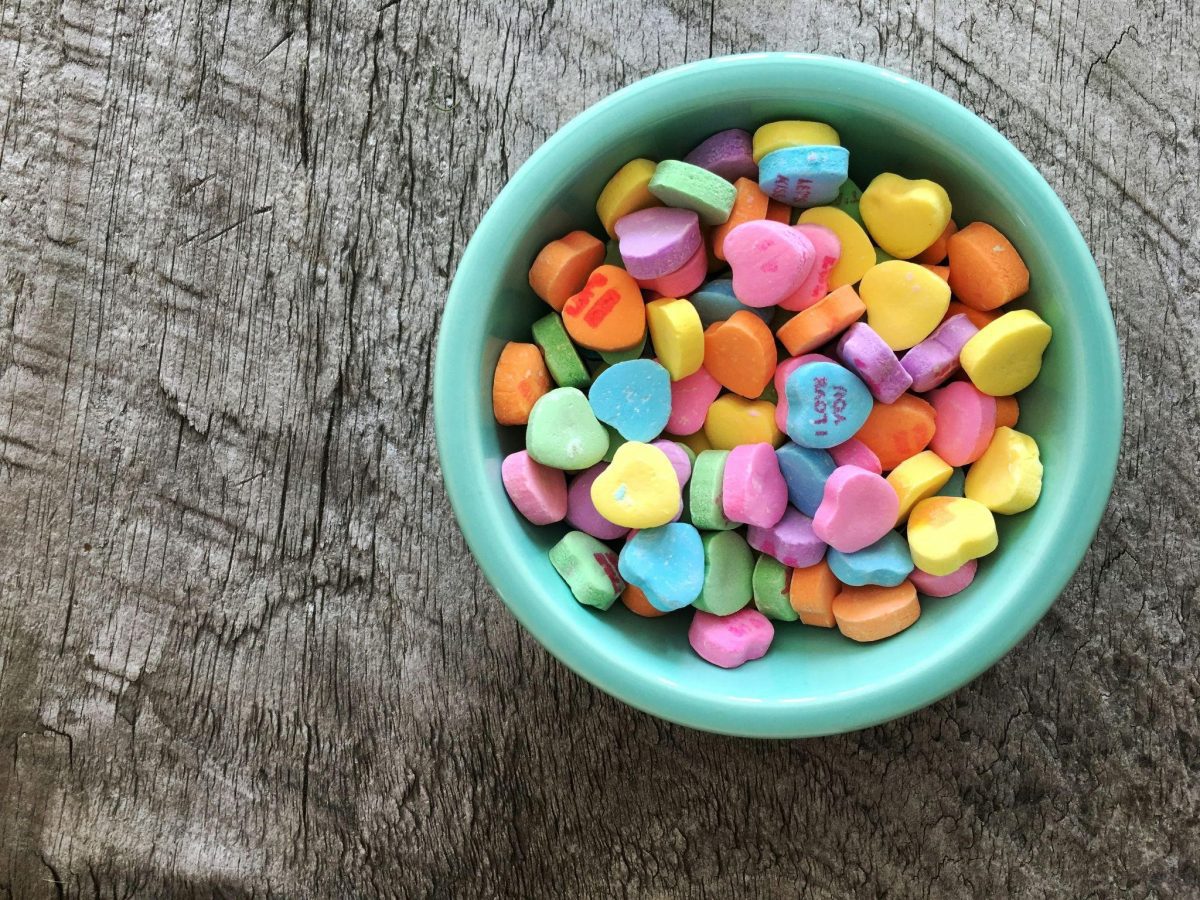 A bowl of colorful candy hearts on a bowl, showcasing colorful homemade candy ideas.