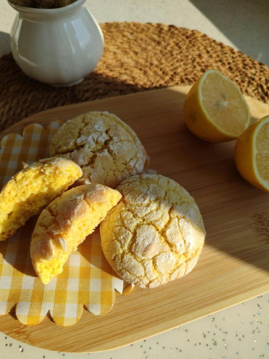 A tray with a lemon and a half-eaten lemon ricotta cookie, highlighting a delicious best lemon ricotta cookie recipe.