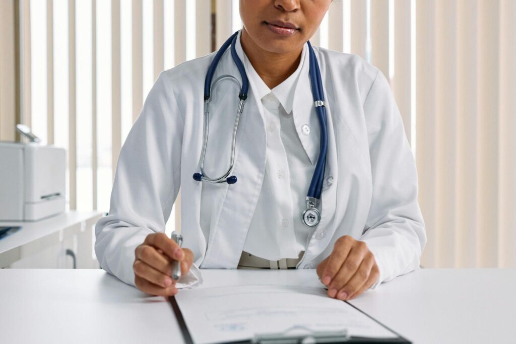 A doctor in preparation to handle a patient, showcasing the essence of caregiver checklist for doctor visits.
