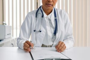 A doctor in preparation to handle a patient, showcasing the essence of caregiver checklist for doctor visits.