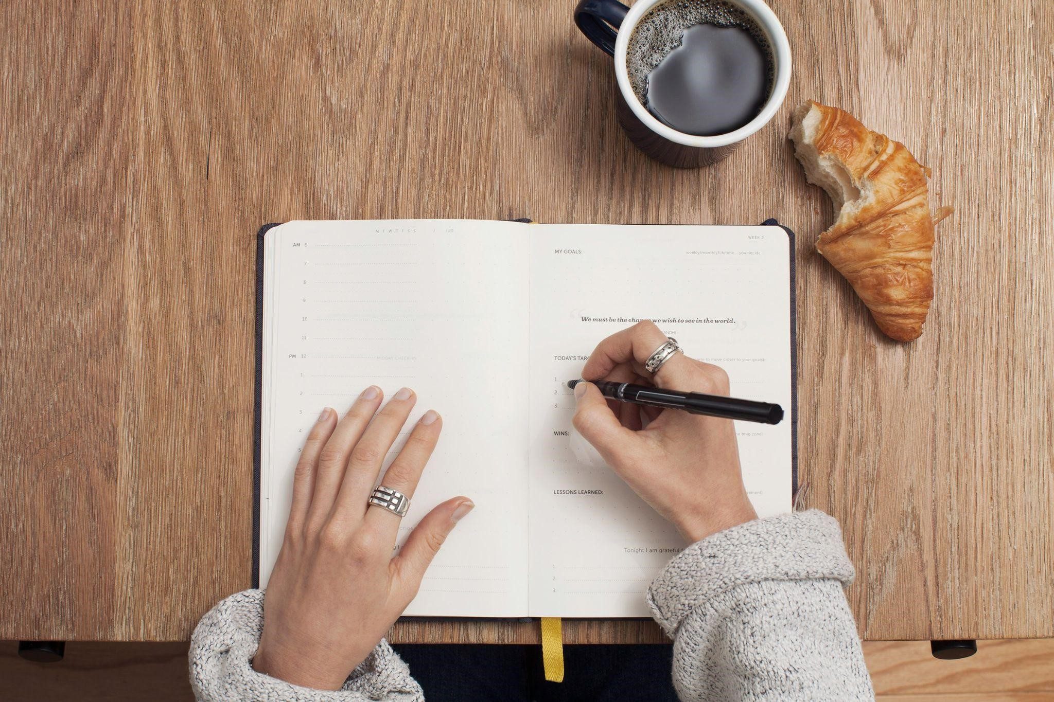 A person writing, symbolizing a daily gratitude list for caregivers to utilise.