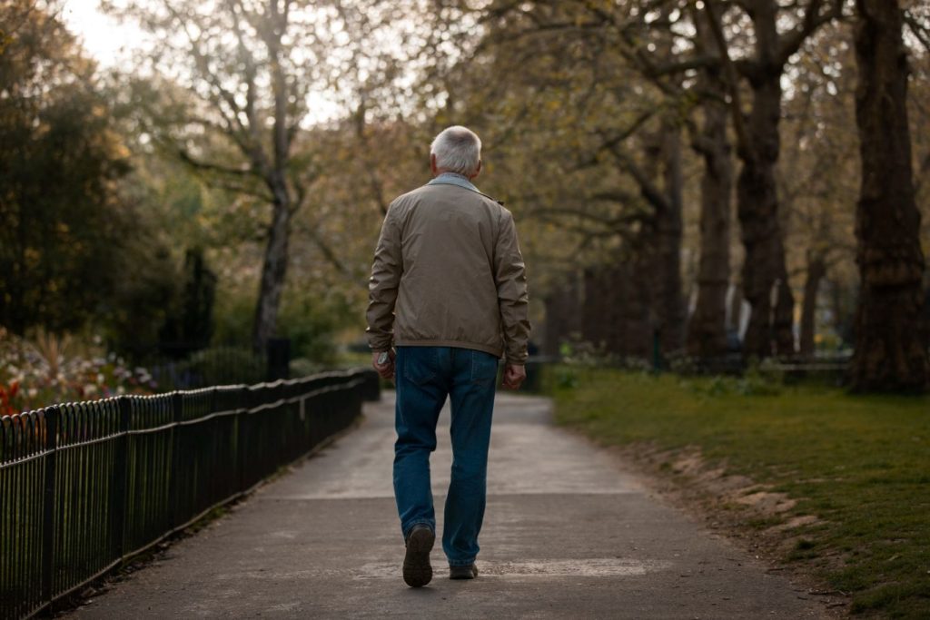 An old man taking a stroll.