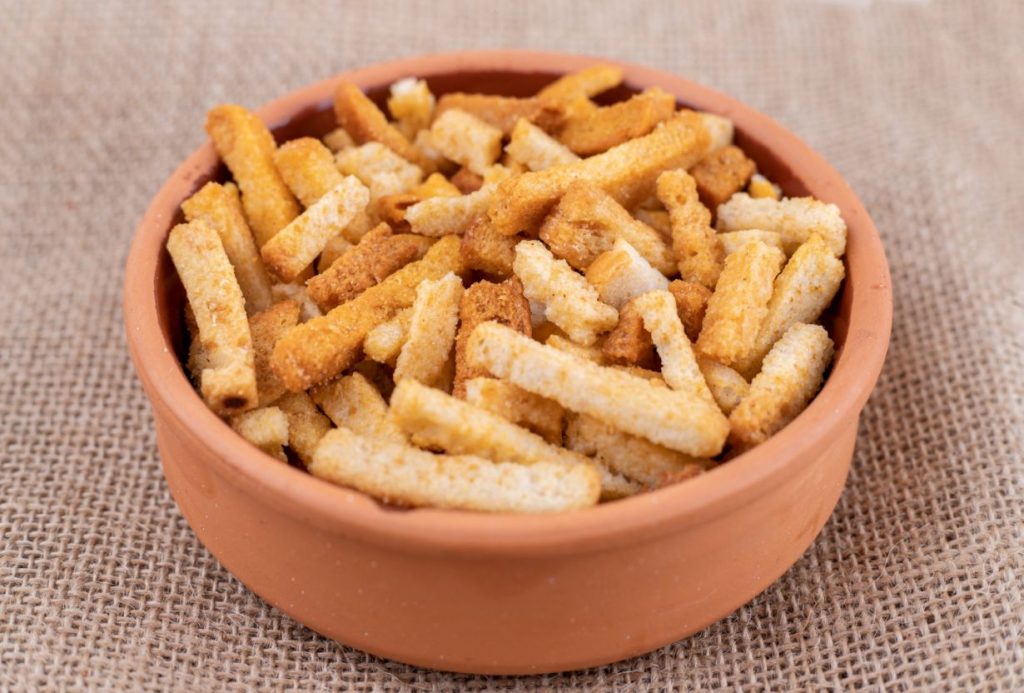 A bowl of small breadsticks.