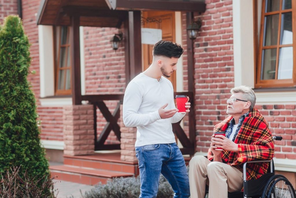 Young man talking with his grandfather.