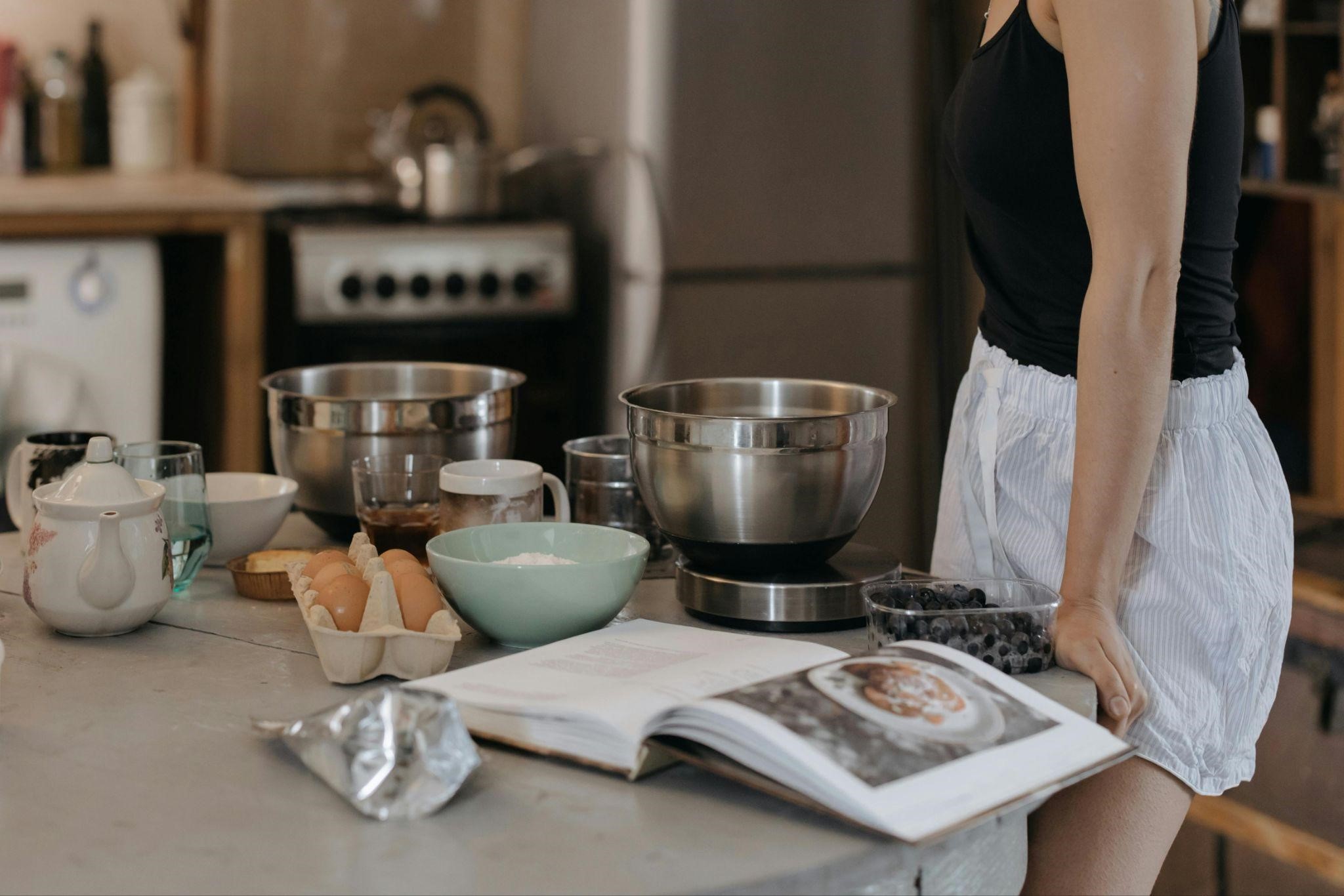 A person stands at a kitchen counter, engaging in holiday meals for beginner home cooks.