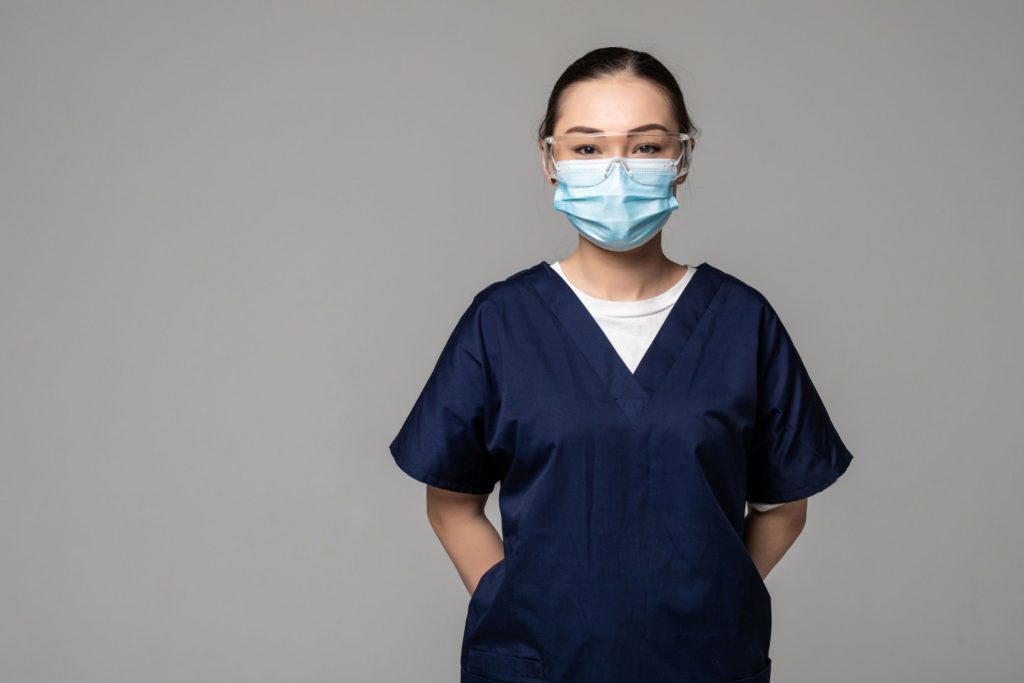 A young caregiver in scrubs.