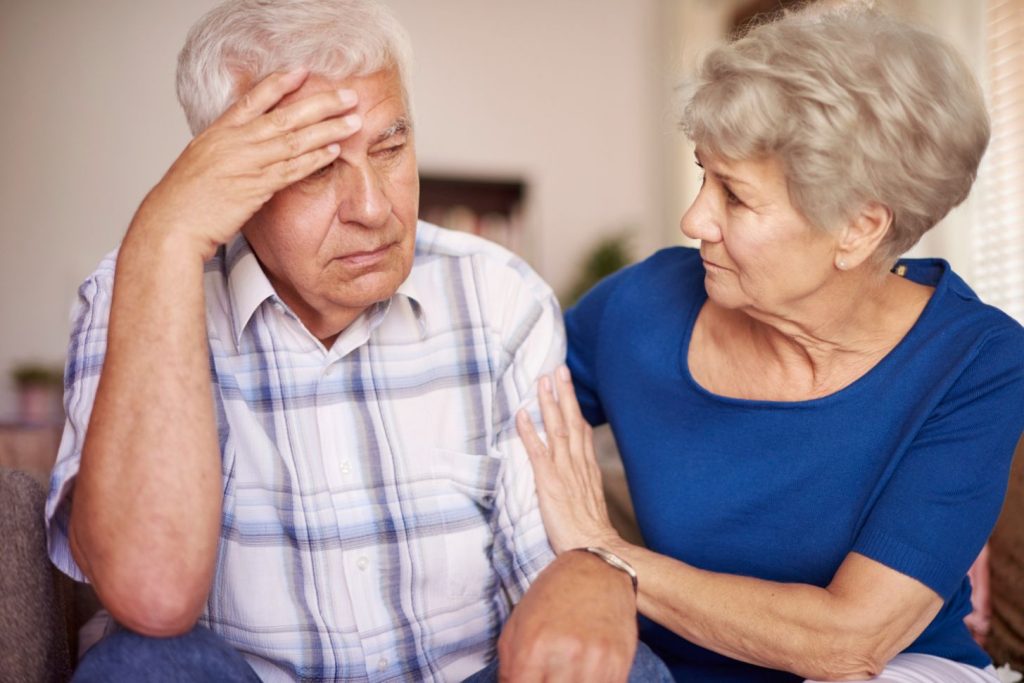 An old woman with her aging spouse. 