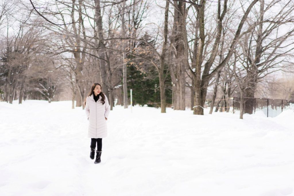 A young woman walking outside in winter.