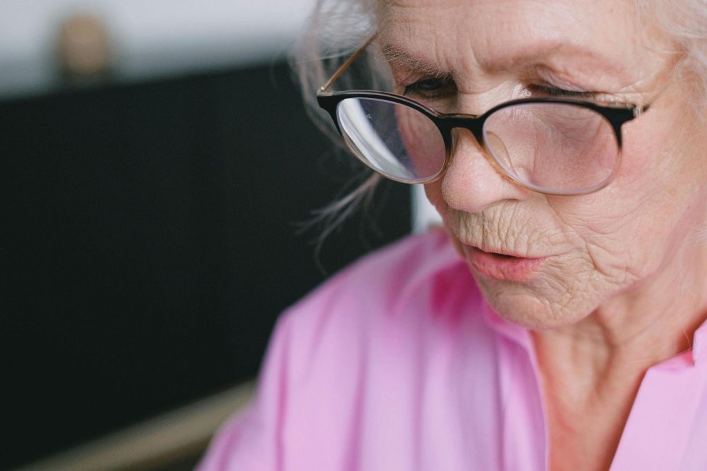 Elderly woman looks focused and contemplative while talking, depicting how dementia patients talk to themselves.