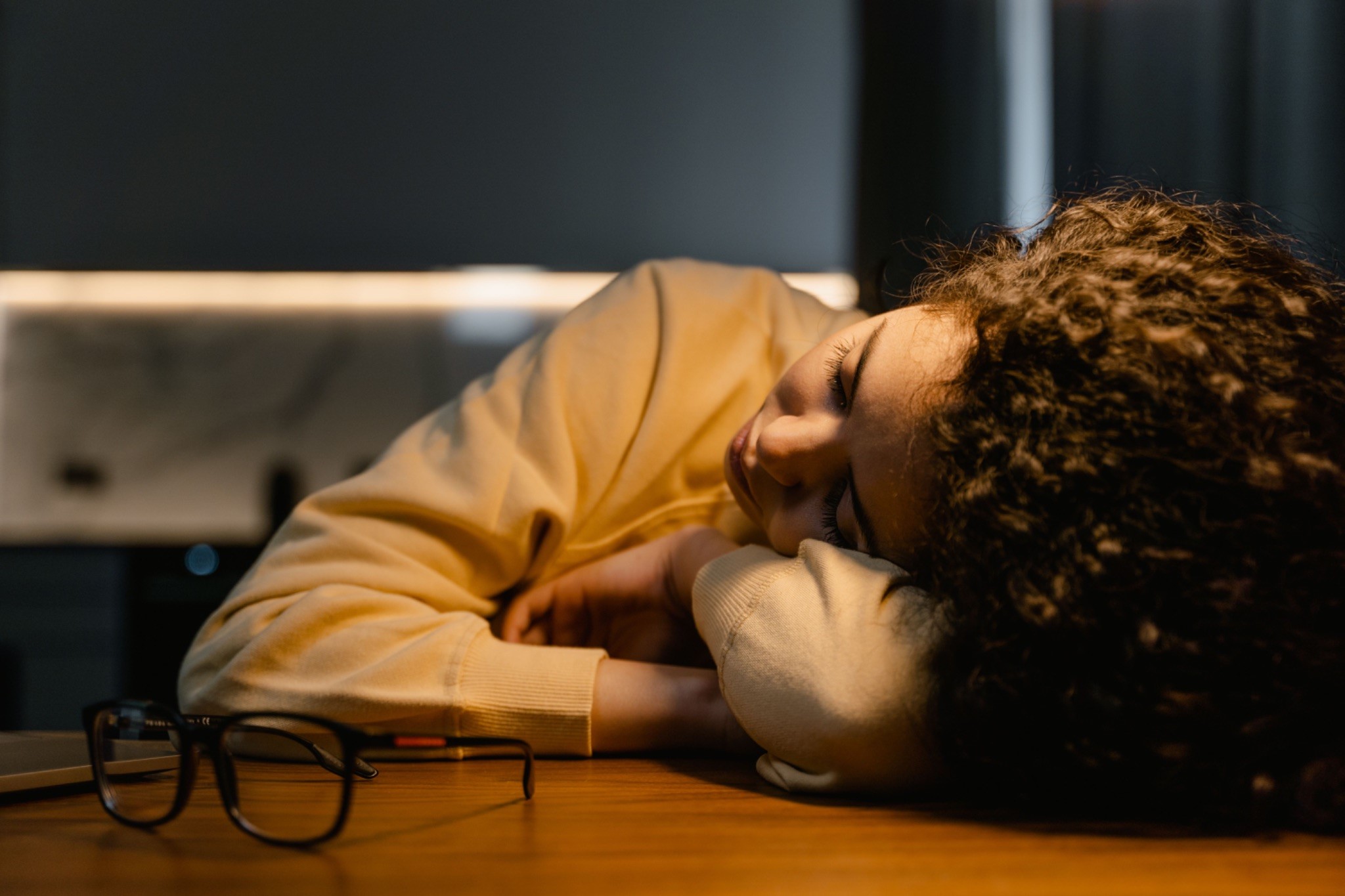 Tired caregiver resting at a table, highlighting how caregivers can recover from exhaustion.