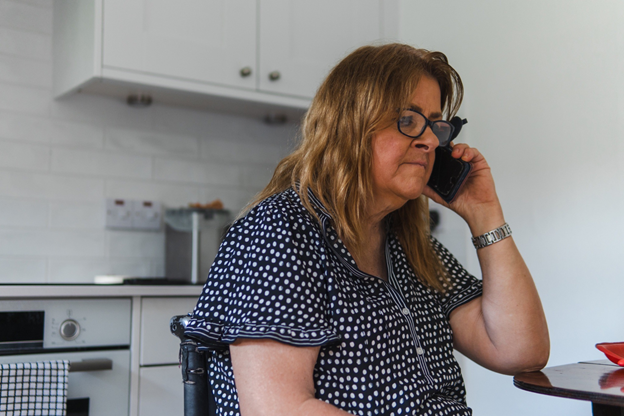 Woman on the phone at home showing how caregivers can recover through emotional support.