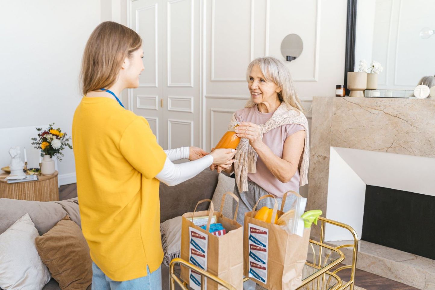A caregiver bringing fruits to her patient.