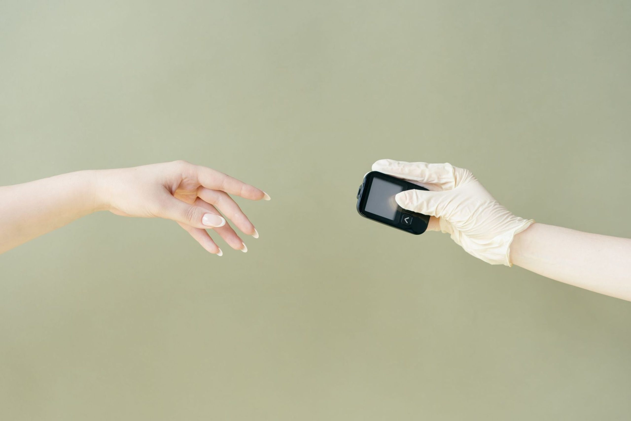 A hand reaching out to an outstretched hand holding a gadget.