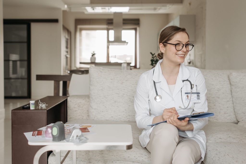 a doctor wearing white sitting down