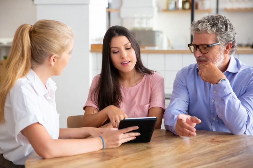 Woman talking to parents | Drawing the line between care and self-preservation is important.