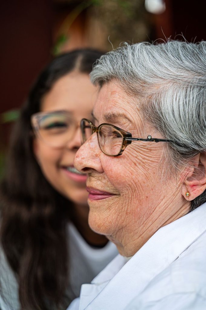 a young caregiver looking after an old female patient