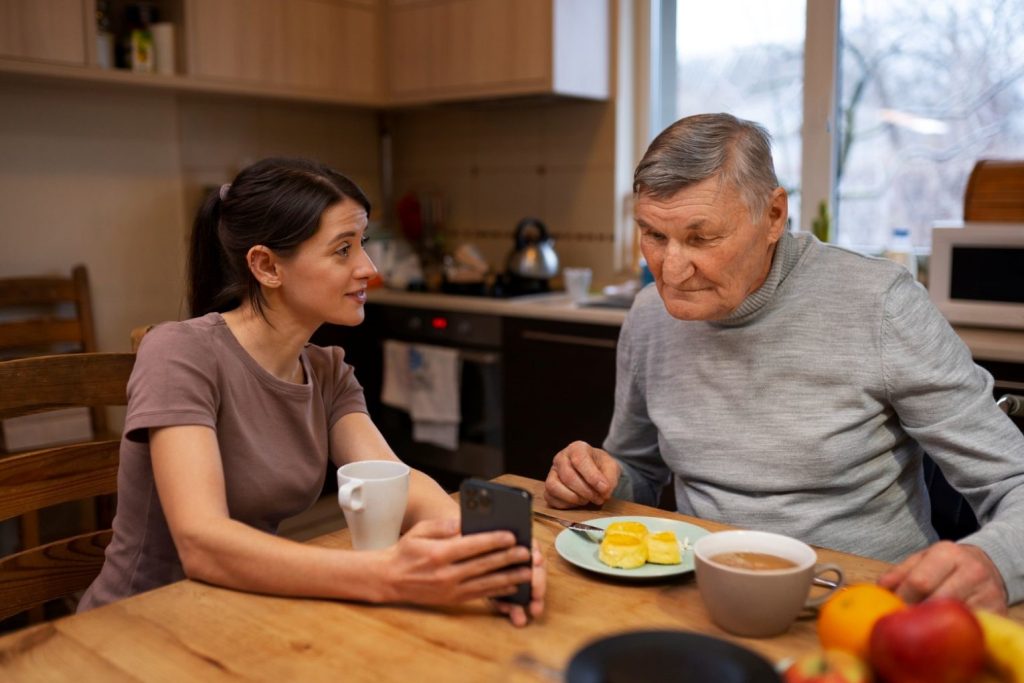 Daughter talking to father over breakfast.