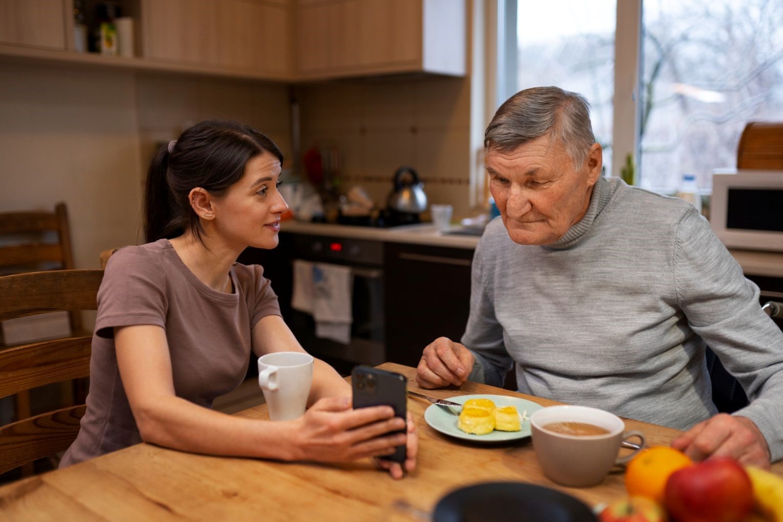 Daughter talking to father over breakfast.