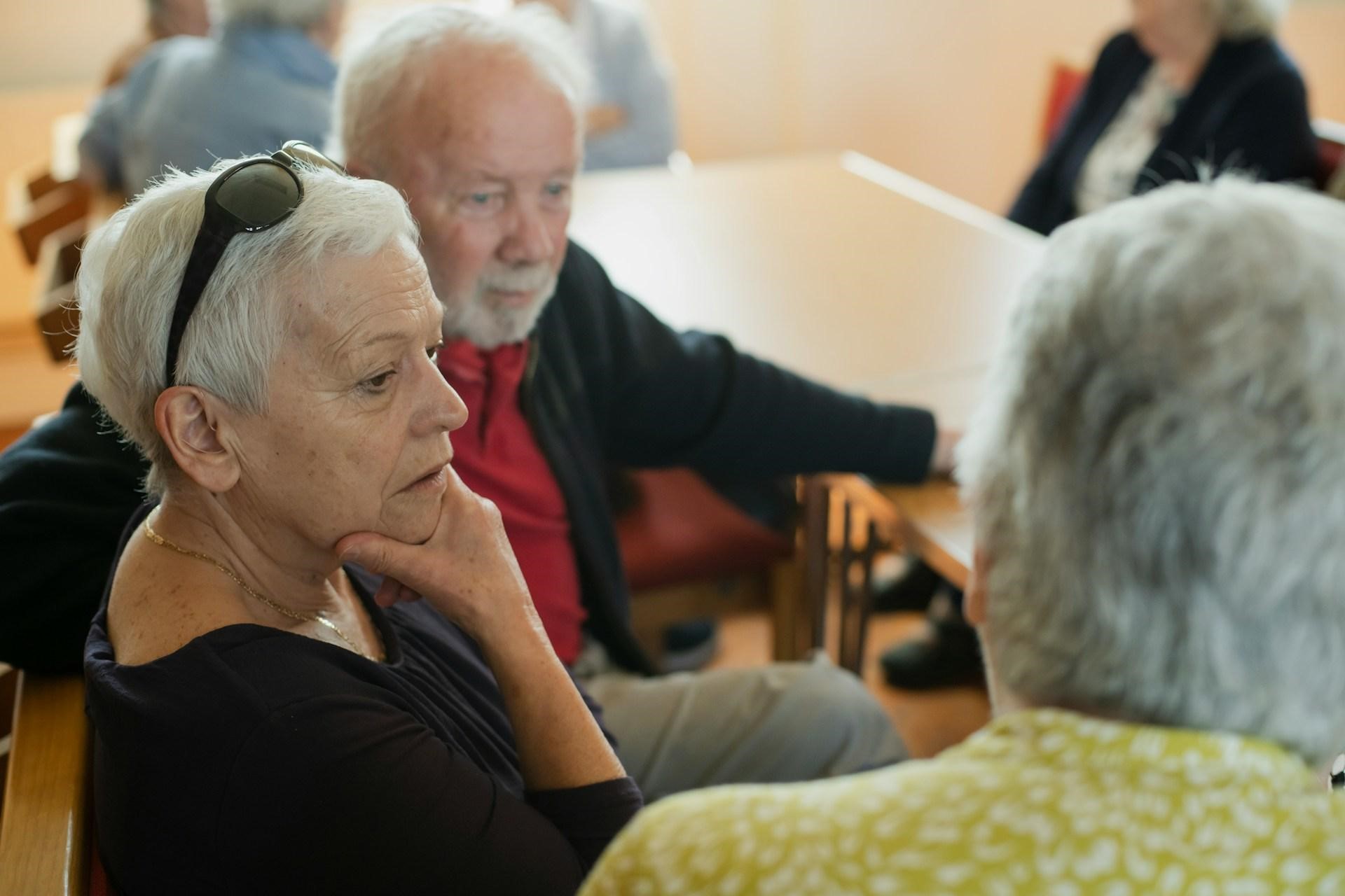 Older adults sit together during a discussion, illustrating when dementia patients make accusations.